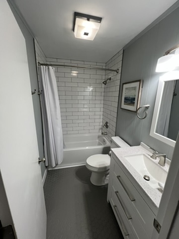 Full bathroom with subway tile shower