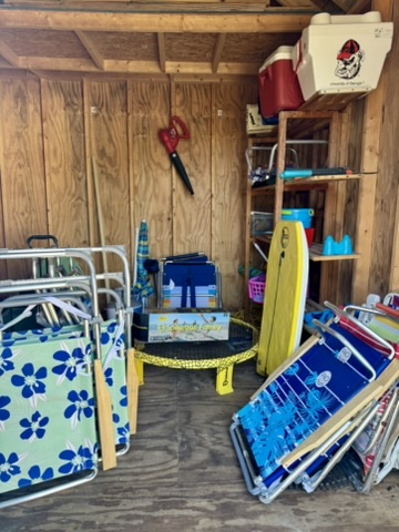 Beach gear shed with chairs and toys